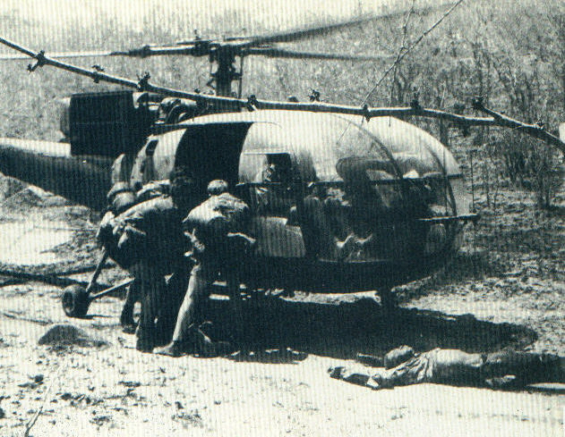 Selous Scouts lift rebel dead aboard a waiting helo after a ambush.